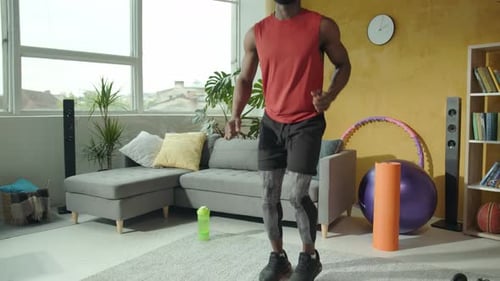 Man Doing High Knees Exercise in Living Room