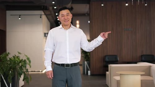 Asian Business Professional Pointing Finger at Wooden Wall for Company Name