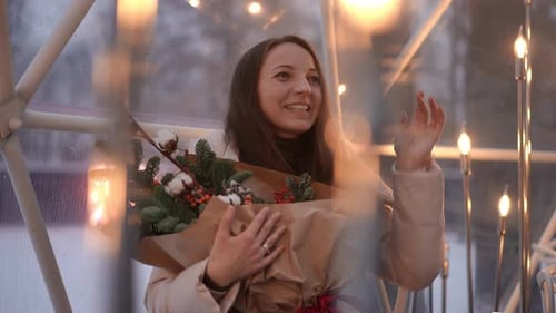 Woman Holds Bouquet of Flowers in Winter Setting