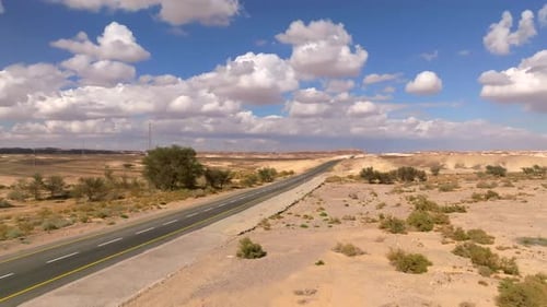 Empty Desert highway mountain road with Blue cloudy sky