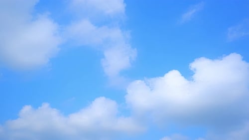 Clouds Moving Slowly in a Bright Blue Sky
