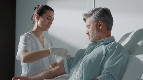 Healthcare Professional Attending to Patient in Hospital
