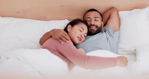 Man and Woman Sleeping Together in Bed