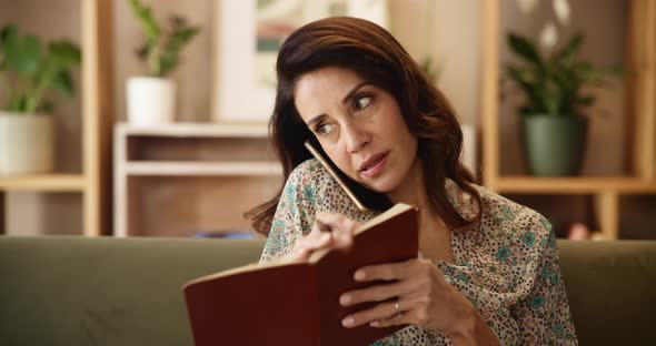 Phone call, notebook and schedule with woman on sofa for calendar ...