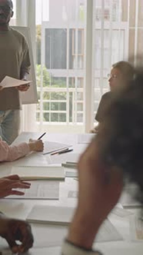 Black Man Speaking by Whiteboard during Lesson