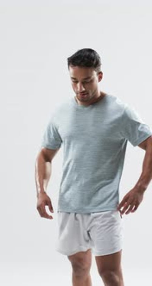 Young Adult Smiles at Camera in Studio