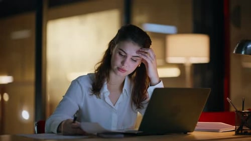 Woman Working Late on Laptop in Office