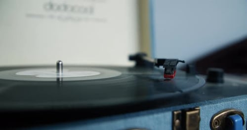 Black Record Spins on Vintage Blue Turntable