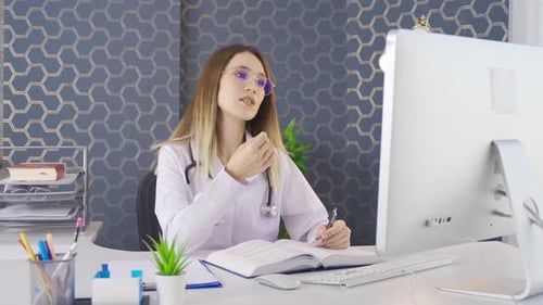 Woman Doctor Telehealth Video Call at Modern Desk