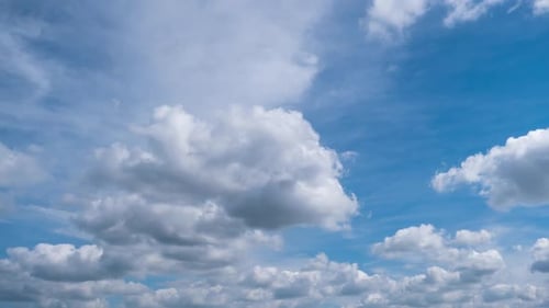 Timelapse of Soft White Cumulus Clouds Move in the Blue Sky