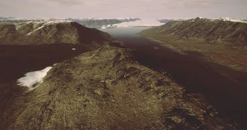 Aerial View of Rugged Mountainous Terrain with Glacier and Valley Details
