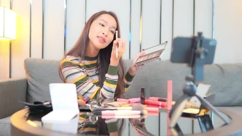 Woman Applying Eye Shadow for a Beauty Tutorial