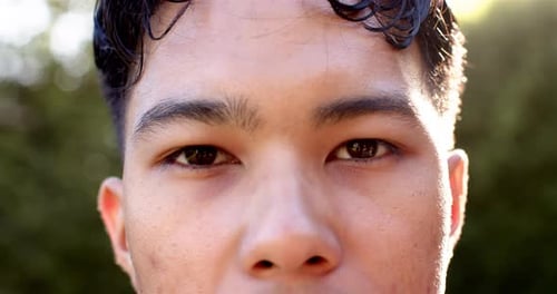 Close-up of man with focused expression outdoors