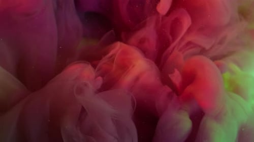 Red and Green Ink Slowly Swirling Together