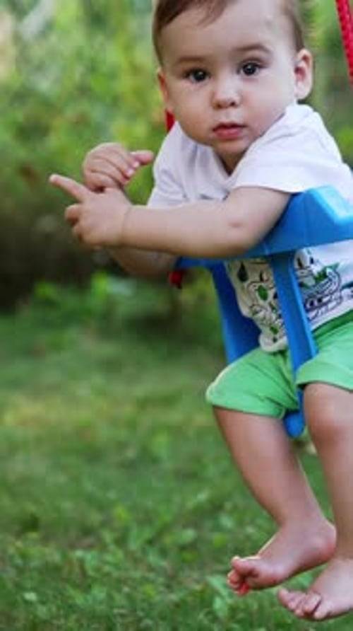 Baby in Swing in Outdoor Setting