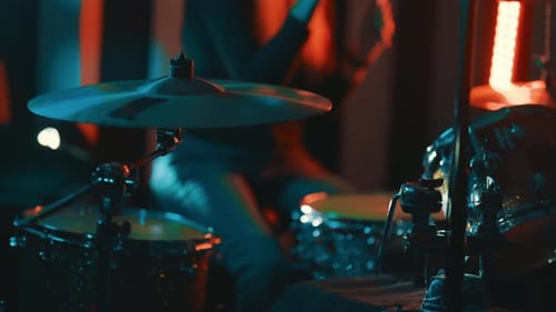 Drummer Plays Music at Night in a Venue