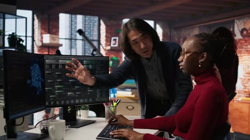 Man in AI Startup Office CTO Position Overseeing Software Engineer Coding