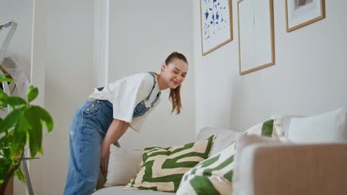 Young Couple Moving Sofa in Modern Living Room Happy Wife Arranging Furniture