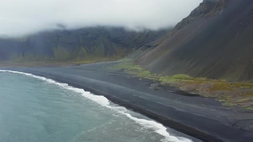 Aerial view of black sand beach and mountain, Iceland.