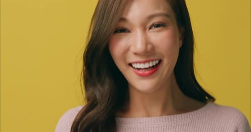 Smiling Woman Portrait in Front of Yellow Background