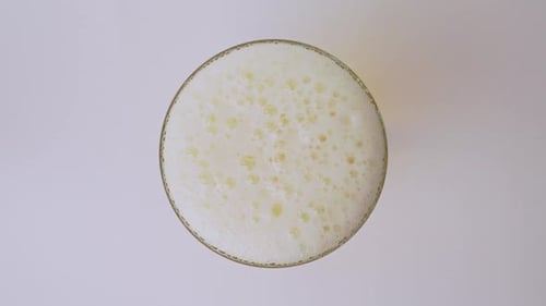 Slow-Motion Close-Up of Bubbling Beer Foam
