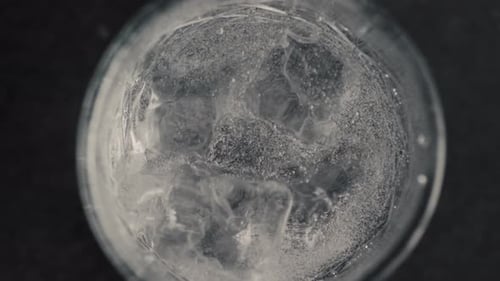 Close up of ice cubes spinning in drink