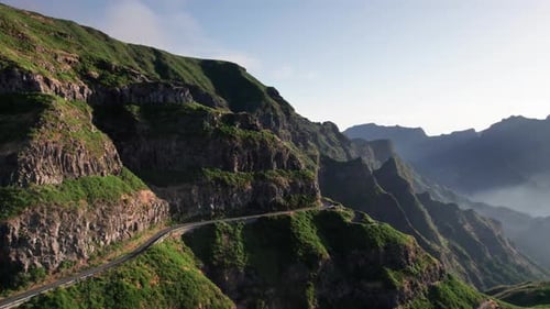 Aerial view of mountain road pass on ridge with lush green vegetation, Madeira
