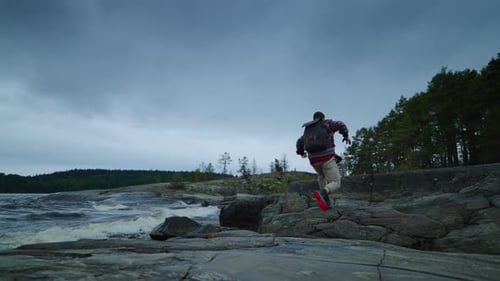 Adventure And Discovery In Nature Man With Backpack Walking Alone In Nature Near Forest And Lake