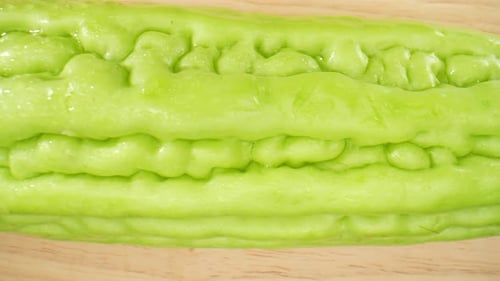 Chinese Bitter Gourd glistens with droplets of water