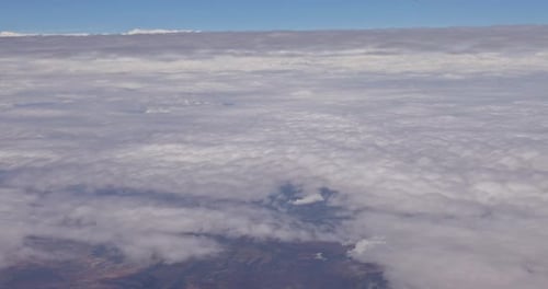 White Fluffy Clouds from Above during the Daytime