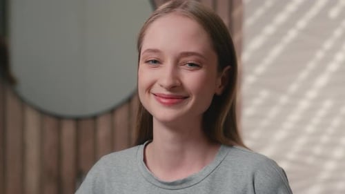 Smiling Young Woman Looking at Camera