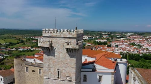 Aerial view of fortified village on hill.