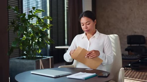 Woman Receives Bad News in Letter at Office