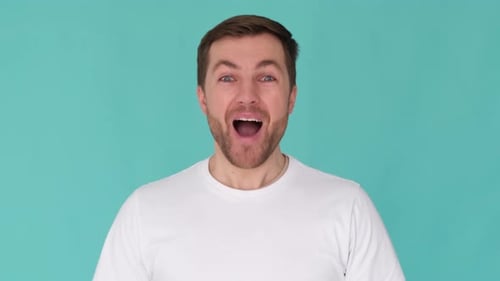 A Portrait of a Man of Caucasian Appearance in the Studio Who Looks Wryly at the Camera and Says Wow