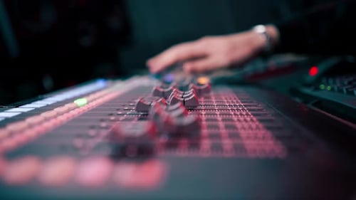 Close Up the Recording Room Dark with Neon Lighting in the Studio the Sound Engineer Works with the