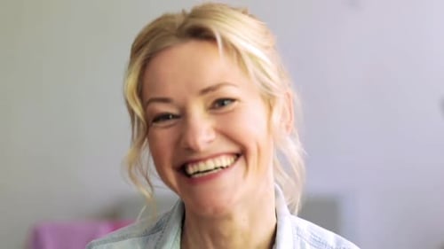 Smiling Woman in Blue Shirt Looking at Camera