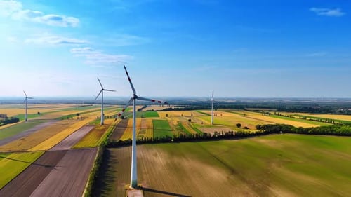 Spectacular fields in the countryside with installed wind turbines. Production of green energy.