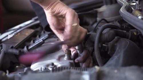 Adult Hands Repairing a Car Engine