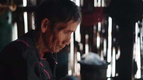 Closeup Asian Elderly Face While Cooking in a House of the Lahu Tribe in Thailand