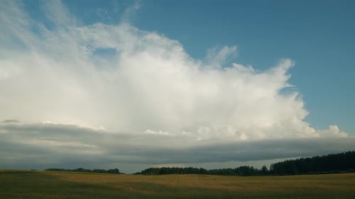 Huge rain clouds cumulus stratocumulus time lapse over countryside fields