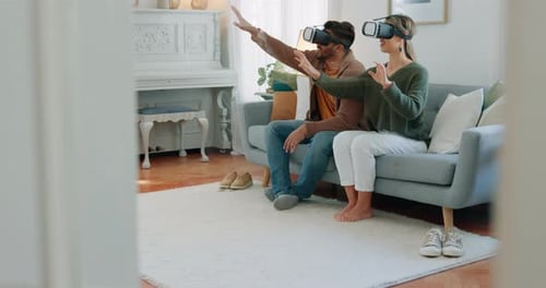 Couple Experiencing Virtual Reality Headsets in Living Room