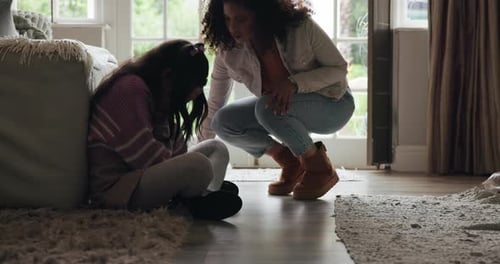 Mother Comforting Child Indoors in Home