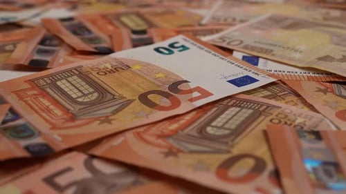 Pile of Orange Fifty Euro Currency Banknotes