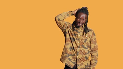 Man With Dreadlocks Frustrated on Orange Background