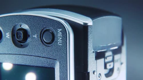 A macro close up shot of a video camera, silver camcorder on a 360 rotating stand, studio lighting,