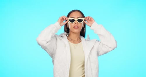 Fashion, sunglasses and portrait of a cool woman with style or modern clothing isolated in studio