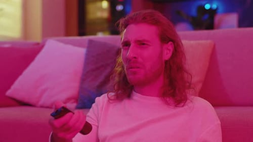 Frightened Young Man Watching Thriller on TV Horror Scene Movie Getting Scared Staying at Night on