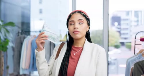 Rich, shopping and woman with money in store excited for purchase, spending or buying clothes