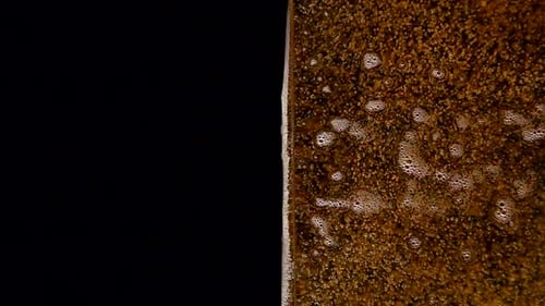 Close Up Brown Fizzy Drink with Rising Bubbles