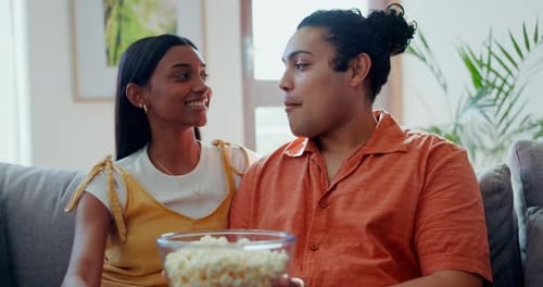 Happy Couple Relaxing on Couch, Eating Popcorn